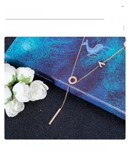 Detailed close-up of a rose gold titanium steel necklace with V-shape and bar pendants