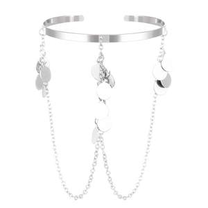 Detailed view of silver arm cuff featuring star sequins and dangling chain tassels