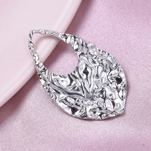 Macro shot of silver 304 stainless steel hammered teardrop pendant with hollow hole