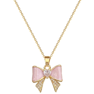 Titanium steel gold necklace featuring a pink enamel bow pendant with white cubic zirconia