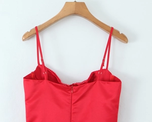 Detail view of red satin dress back with lace trim, thin straps and hidden zipper
