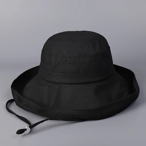 Detail of black cotton sun hat featuring reinforced stitching and adjustable chin strap