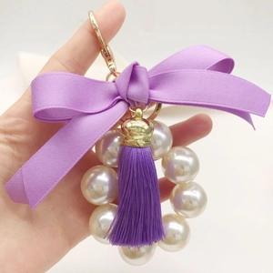 Fashionable purple ribbon bow keychain with pearl ring and fringe tassel charm