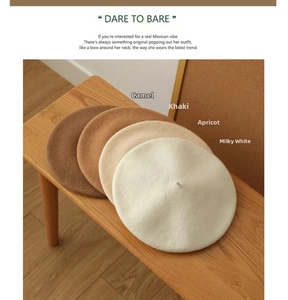 Close-up of wool beret collection in camel, khaki, apricot, and milky white colors