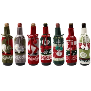 Knitted Christmas wine bottle covers with gnome and reindeer patterns in multiple colors