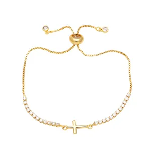 Verstellbares goldenes Kreuzarmband mit Zirkonia-Inlay und Boxkette auf Weiß