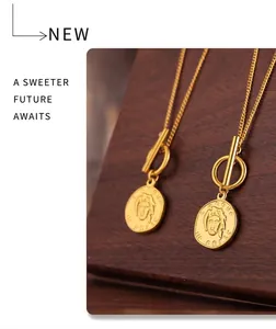 Detail of vintage 18k gold plated portrait coin pendant necklace with OT toggle clasp