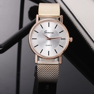 Detailed close-up of rose gold quartz watch with mesh strap and sunray dial texture