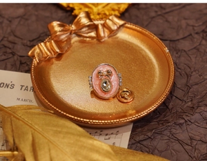 Detail of pink vintage enamel flower brooch with rhinestones and rear pin closure mechanism