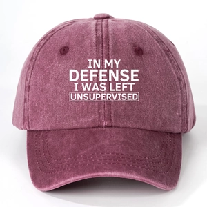 Close-up detail of vintage washed cotton baseball cap featuring embroidered white slogan text