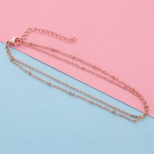 Detail of rose gold double-layer bead chain with lobster clasp and extension link