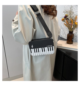 Detail of piano keyboard pattern crossbody bag with I Love Music print and wide strap