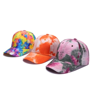 Detailed view of colorful tie-dye baseball caps showing vibrant fabric texture and stitching