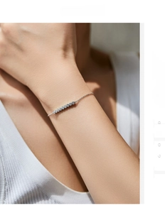 Close-up of minimalist S925 silver bracelet with seven sparkling inlaid round stones