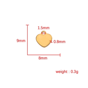 Polished gold heart charm pendant with 9mm height and 8mm width dimensions shown