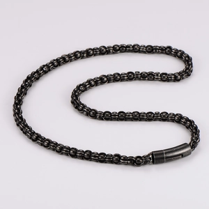 Detail of dark gunmetal Byzantine chain necklace featuring a cylindrical clasp on white back