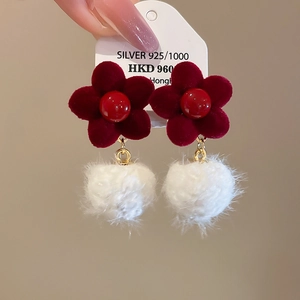 Detail of red flocked flower earrings with soft white pompom and 925 silver needle