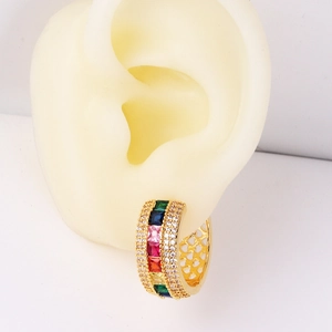 Minimalist gold hoop earrings featuring multi-colored gemstones on a model display