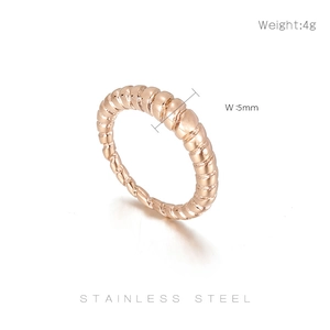 Detail view of rose gold twisted croissant ring with 5mm width and stainless steel text