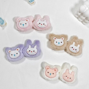 Detail of plush bear and rabbit hair clips featuring soft pink and purple pastel embroidery