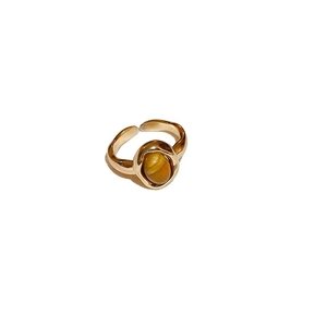 Vintage gold open ring featuring an oval tiger eye stone with irregular textured band