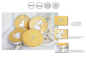 Macro shot of wooden curtain tiebacks featuring deer and cactus motifs with magnetic clips