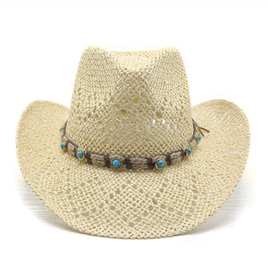 Ethnic beige straw cowboy hat with hollow weave and turquoise band on white background