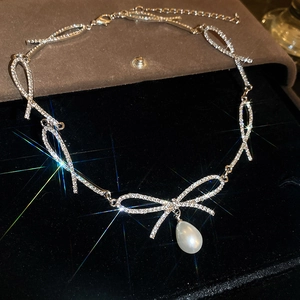 Elegant silver bow choker necklace with sparkling rhinestones and teardrop pearl pendant