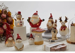 Detailed arrangement of ceramic Christmas figures with scented tea candles on display