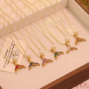 Detailed view of fish tail pendant necklaces with pearl accents and colorful enamel inlays