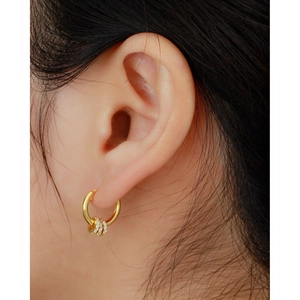 Close-up of S925 silver gold hoop earrings with three dangling pave-set zircon rings