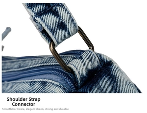 Detailed view of bronze metal rings connecting denim shoulder straps with sturdy stitching
