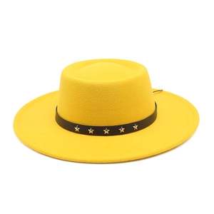 Close-up of yellow wool boater hat featuring a black leather band with silver star studs