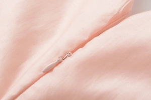 Close-up of pink satin dress featuring a high-quality hidden zipper and fine stitching