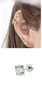 Detail of silver stud earring with mint green zircon in a four-prong claw setting
