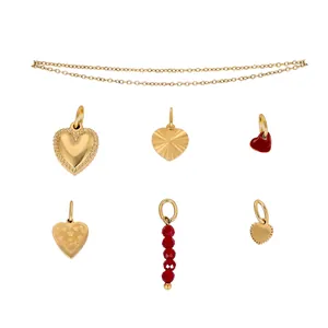 Golden heart charms set in stainless steel featuring red enamel and textured patterns