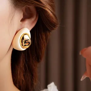 Elegant gold plated enamel teardrop earring with number 5 in vintage cream style
