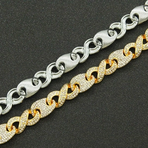 Macro detail of iced-out gold and polished silver cuban chain bracelets with 8-shape links