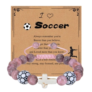 Pink zebra stone football bracelet with white cross charm on I Heart Soccer card