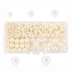 Detailed size comparison of multi-size white faux pearls in a clear storage organizer box