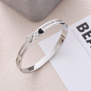Elegant 18K silver-tone stainless steel heart bangle with black and white pavé crystals