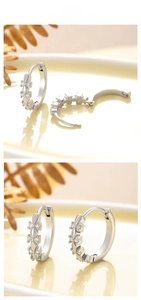 Close-up of elegant silver earrings with sparkling cubic zirconia on a warm ceramic tray