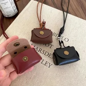 Mini leather pouch necklaces in burgundy, brown and black with metal snap buttons
