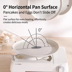 Non-stick minimalist crepe pan with wood texture handle on a white portable stove