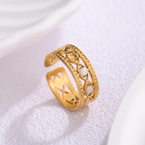 Detailed close-up of a gold-plated stainless steel open ring with eye-shaped cutouts