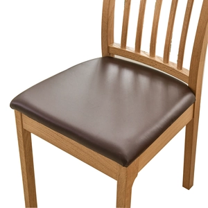 Waterproof PU leather chair seat cover in dark brown on a solid wood dining chair