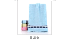 Close-up of thick absorbent cotton towels in blue, yellow, and pink with stripe detail