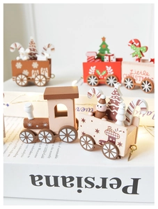 Close-up of wooden Christmas train with snowflake patterns and mini holiday figurines