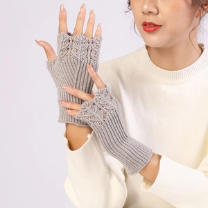 Close-up of gray knit fingerless gloves with delicate openwork pattern on a model