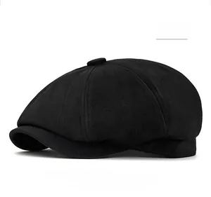 Detail of black octagonal newsboy hat showing fine suede texture and panel stitching